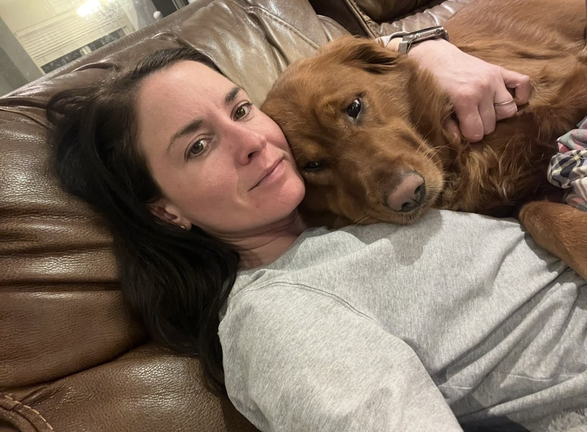 Amelia Fordeck cuddling Shelby on the couch
